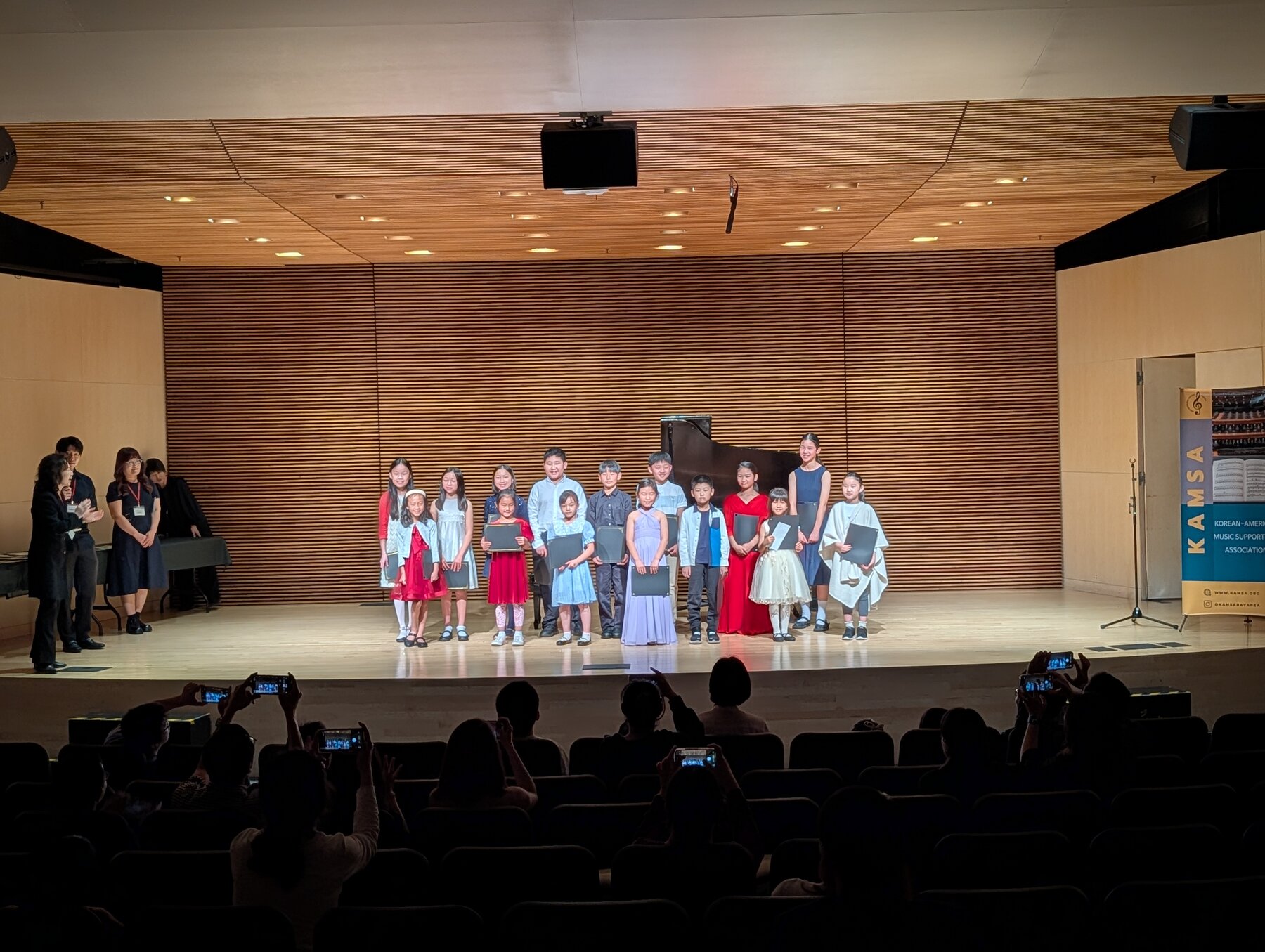 Hailey Murata on stage with other winners at the KAMSA concert